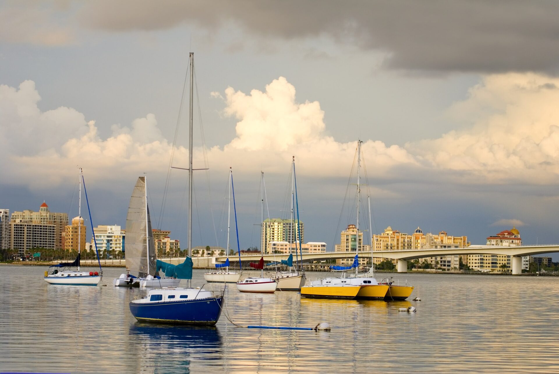 michael-denning-LXomcUwf4vQ-unsplash Boats in a harbor under a cloudy sky
